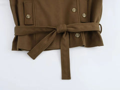  Women's jacket with a belt and zipper closure.