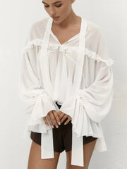 Close-up of the ruffled neckline and draped tie details