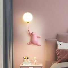 Golden Atelier LED wall lamp in the shape of a friendly cartoon bear, mounted on a wall in a child's room and casting a soft glow. Pink Bear