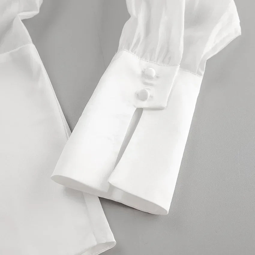 White shirt with rolled-up sleeves on a light gray background