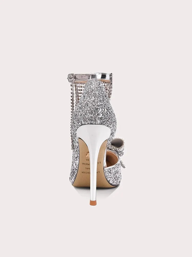 Silver high-heeled shoe with sparkling design on a white background