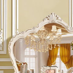 Decorative mirror with intricate detailing in a room with yellow walls and curtains.