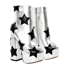 Silver platform boots with black star patterns on a white background