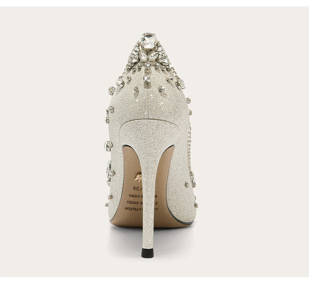 Silver high-heeled shoe with embellishments on a white background