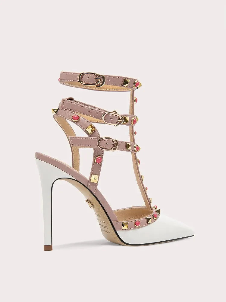 High-heeled sandal with studded design on a light gray background