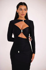 Woman wearing a black dress with cut-out design on a white background