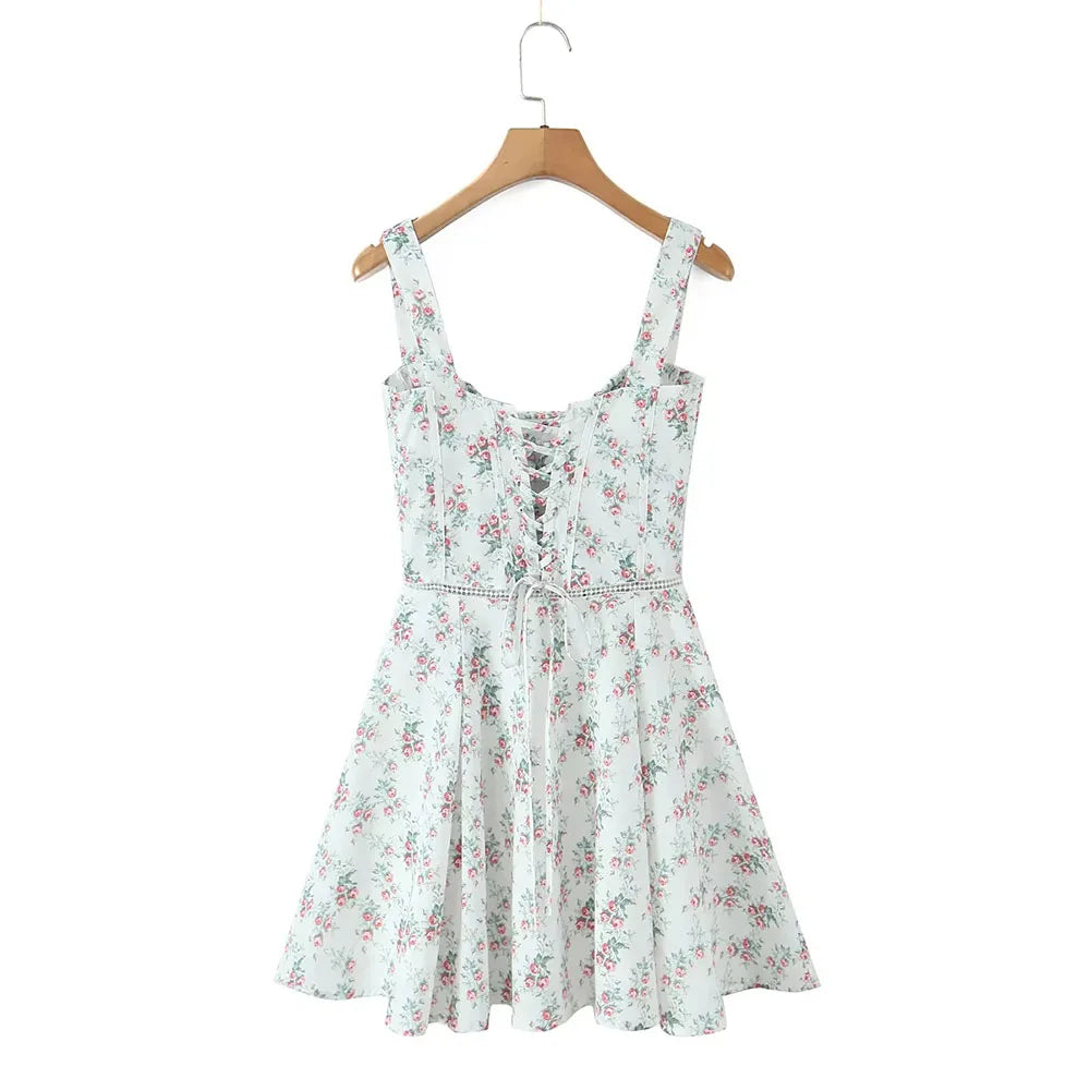 Floral dress on a hanger against a white background