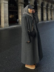 Women's long coat with a striped pattern and oversized fit.