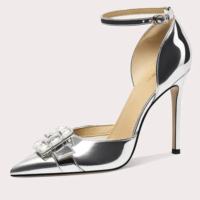 Silver high-heeled shoe with a decorative bow on a white background