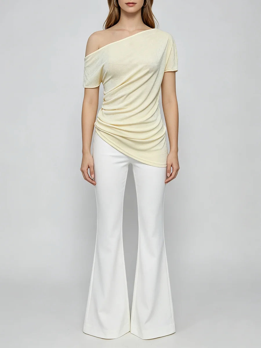 Full body view of a person wearing a diagonal collar asymmetrical top