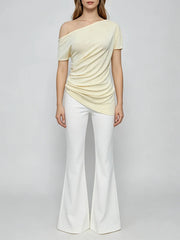 Full body view of a person wearing a diagonal collar asymmetrical top
