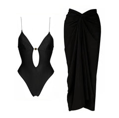 Black monochrome two-piece swimwear set with cutout detail and matching draped skirt.