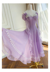 Flowing A-line midi dress with off-shoulder lace trim and chiffon sleeves in motion.