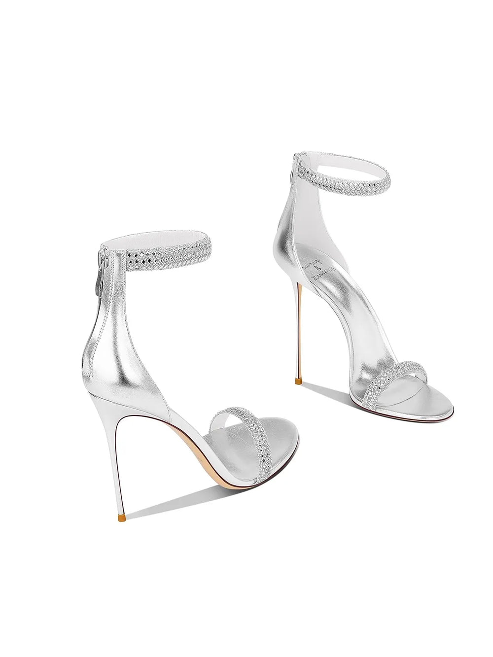 Clear high-heeled sandals with rhinestone embellishments on a white background
