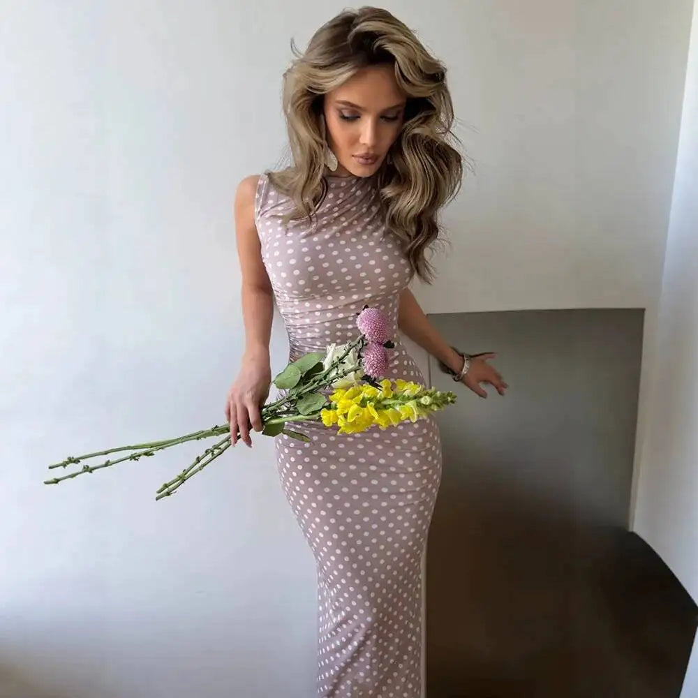 Close-up of an apricot polka dot ruched column maxi dress.