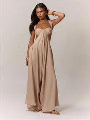 Woman wearing a beige strapless jumpsuit against a plain background