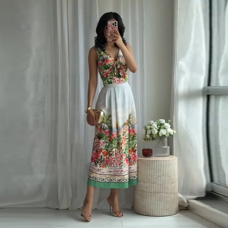 Woman in floral print V-neck sleeveless crop top and floral print pleated A-line midi skirt.