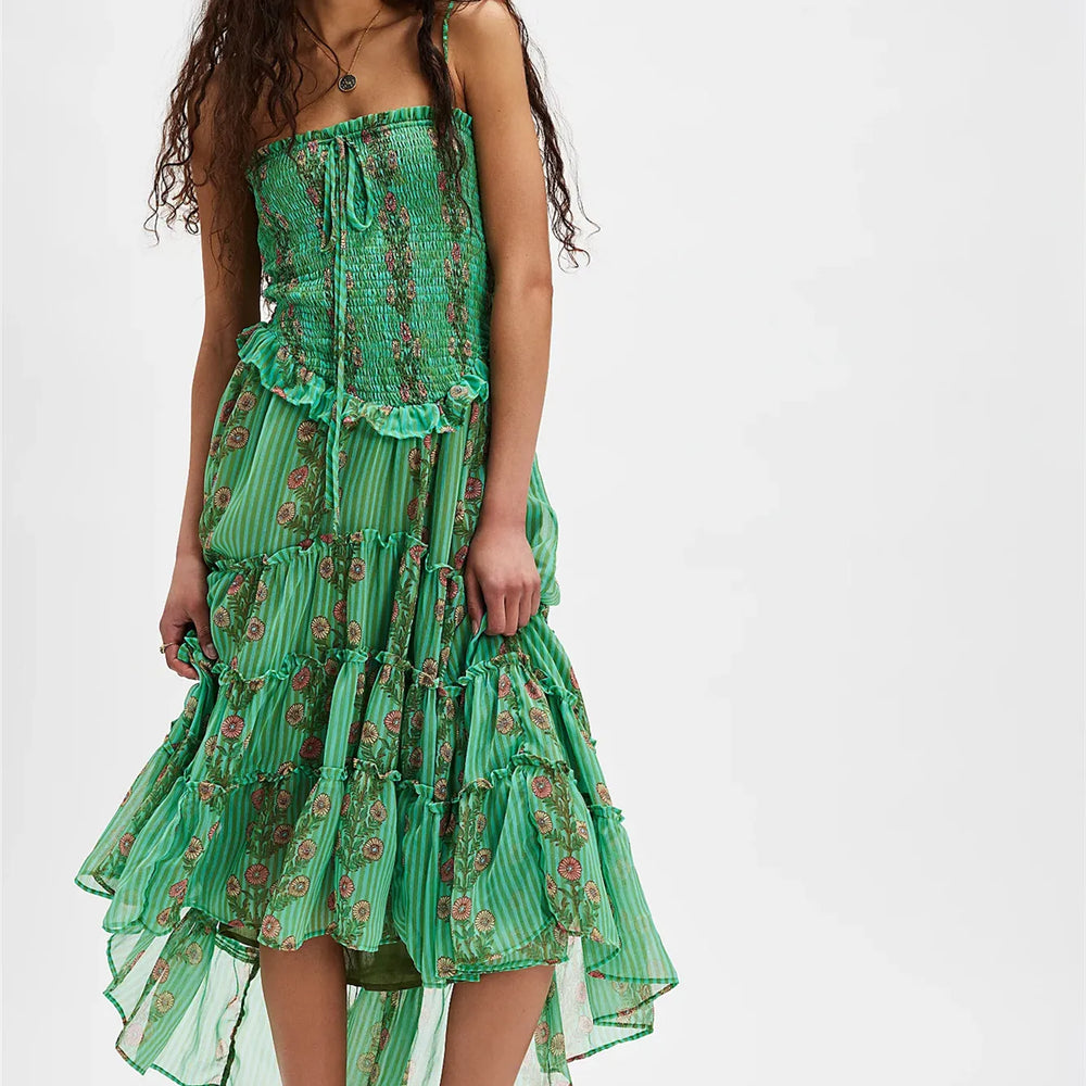 Green floral dress worn by a model on a white background