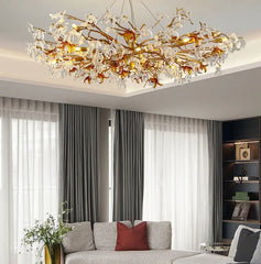 Modern living room with a decorative chandelier, gray sofa, and white curtains.