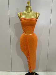 Orange dress on a mannequin against a plain background