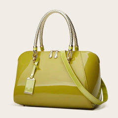 Lime green patent leather Boston bag with braided handles and shoulder strap.