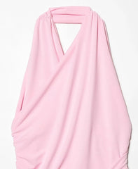 Pink scarf draped over a white background