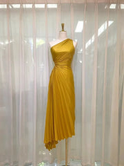 Golden yellow asymmetrical one-shoulder gown on a mannequin.