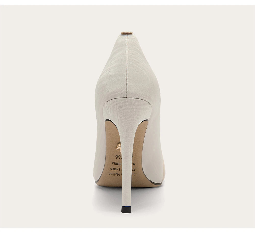 White high-heeled shoe on a white background