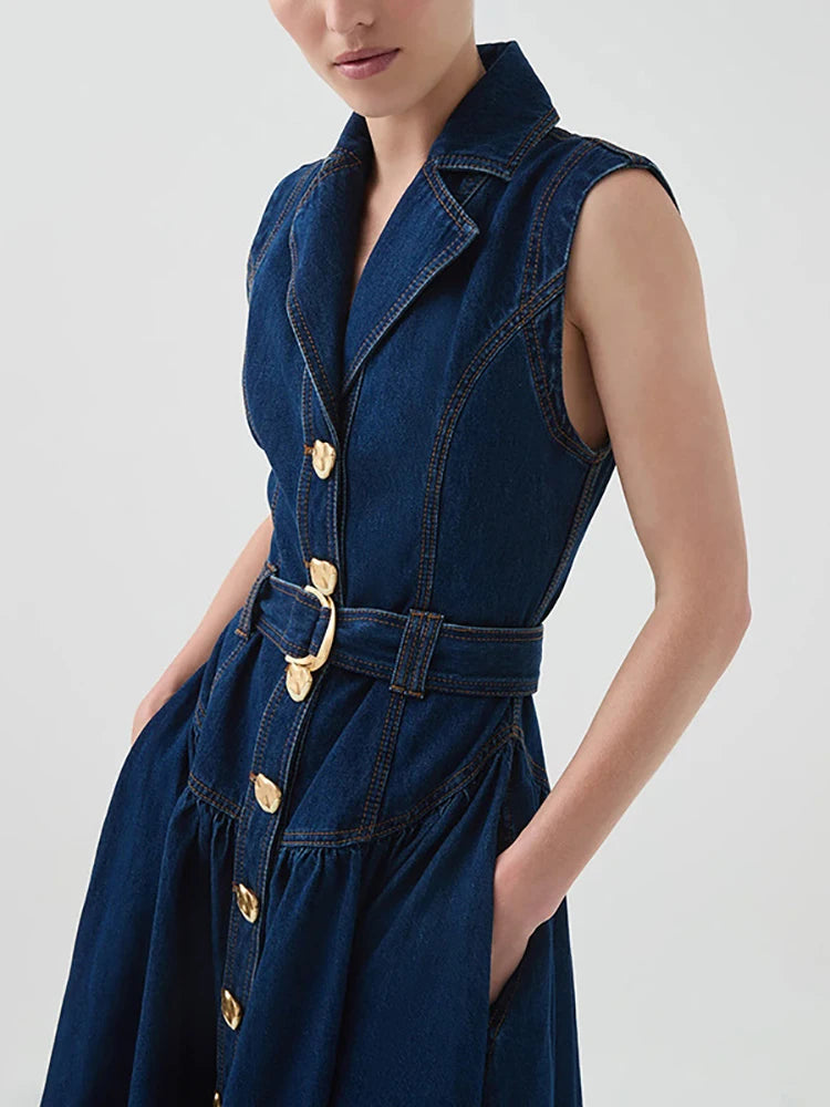 Blue denim dress with gold buttons and belt on a white background