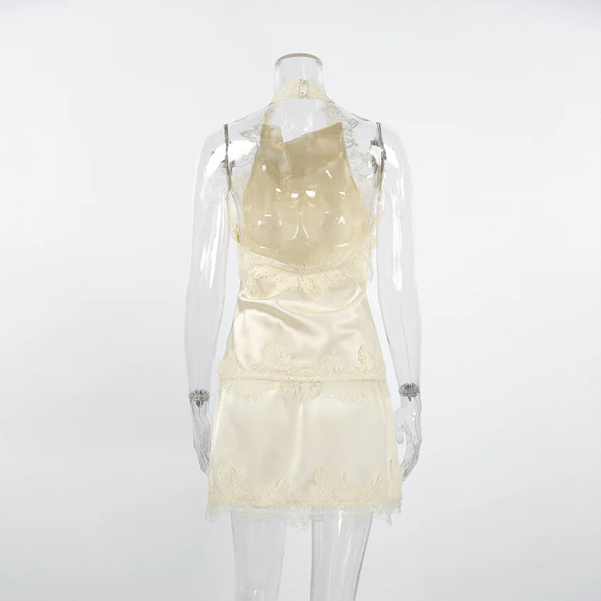 Mannequin wearing a light-colored dress with lace details on a white background