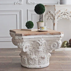 Carved white Corinthian-style coffee table with rustic wood top in modern vintage room