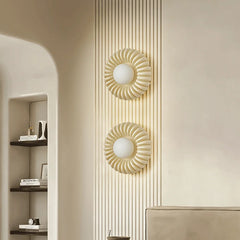 A pair of Parisian wall sconces flanking a vintage mirror, adding a touch of elegance to a Parisian-style living room. A