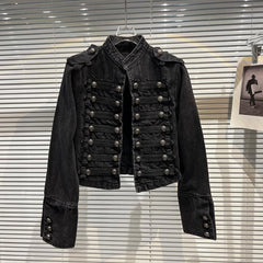 Front view of a black denim jacket with a stand-up collar and double-breasted button closure.
