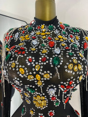 Close-up of colorful rhinestone embellishments on black mesh mini dress