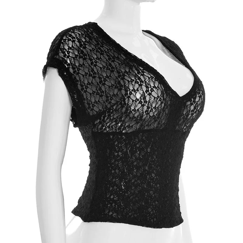 Black lace top on a mannequin against a white background
