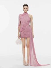 Woman wearing a pink one-shoulder dress on a white background