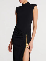 Black dress with a gold zipper on a white background