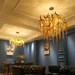 A luxurious French tassel chandelier with a golden finish illuminating a stylish living room. C