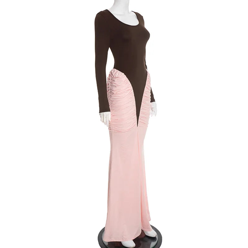 Mannequin wearing a dress with a brown top and pink ruffled skirt on a white background