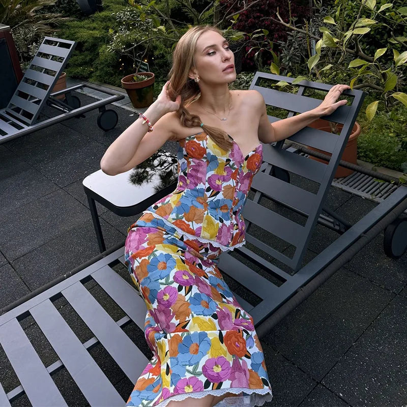 Model relaxing in floral print strapless peplum top and midi skirt set