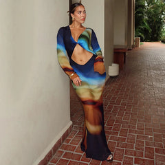 Woman wearing a colorful dress standing on a brick path.