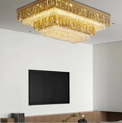 Gold square chandelier in a modern living room setting with a TV and decorative elements.
