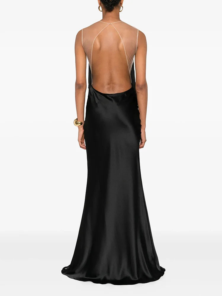 Black evening gown with open back on a white background