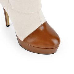 Close-up of the toe and platform on canvas and brown leather ankle boots.