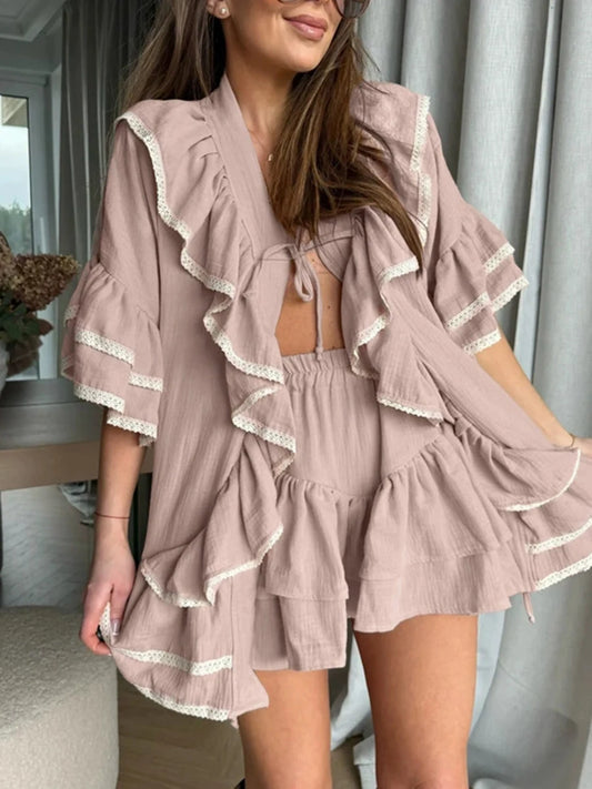 Pink ruffled V-neck top with flared sleeves and lace trim paired with a ruffled mini skirt.
