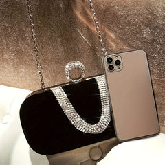 A glamorous rhinestone clutch purse with a delicate chain strap, showcasing its sparkling design and Mobile .