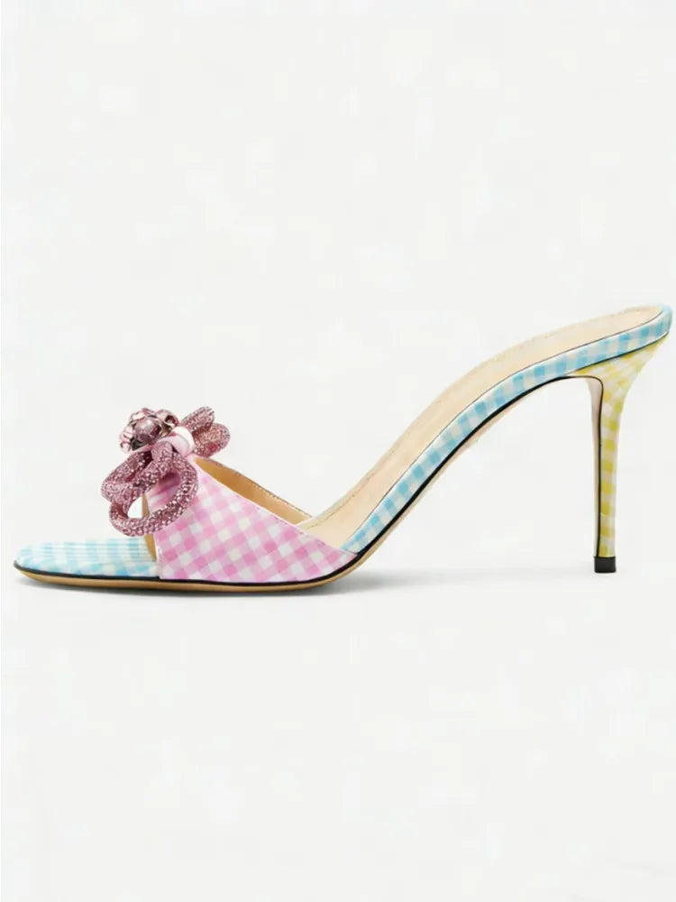 Polka dot high-heeled shoe with pink checkered pattern on a white background