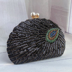 A close-up of a vintage-style clutch bag, showcasing intricate bead embroidery and a clasp closure.