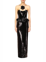 Black sequin evening gown with floral detail on a white background