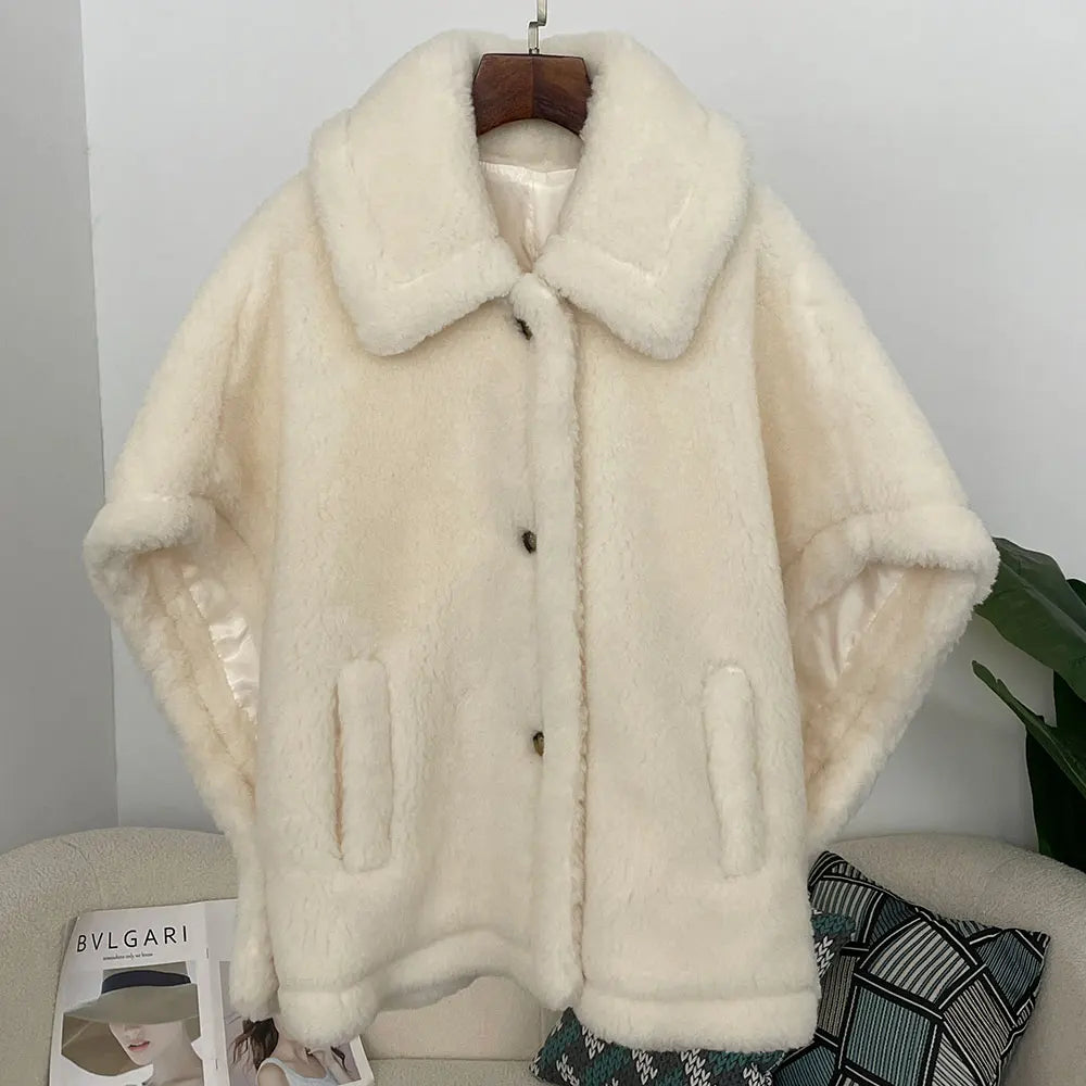 White fur coat on a hanger against a neutral background